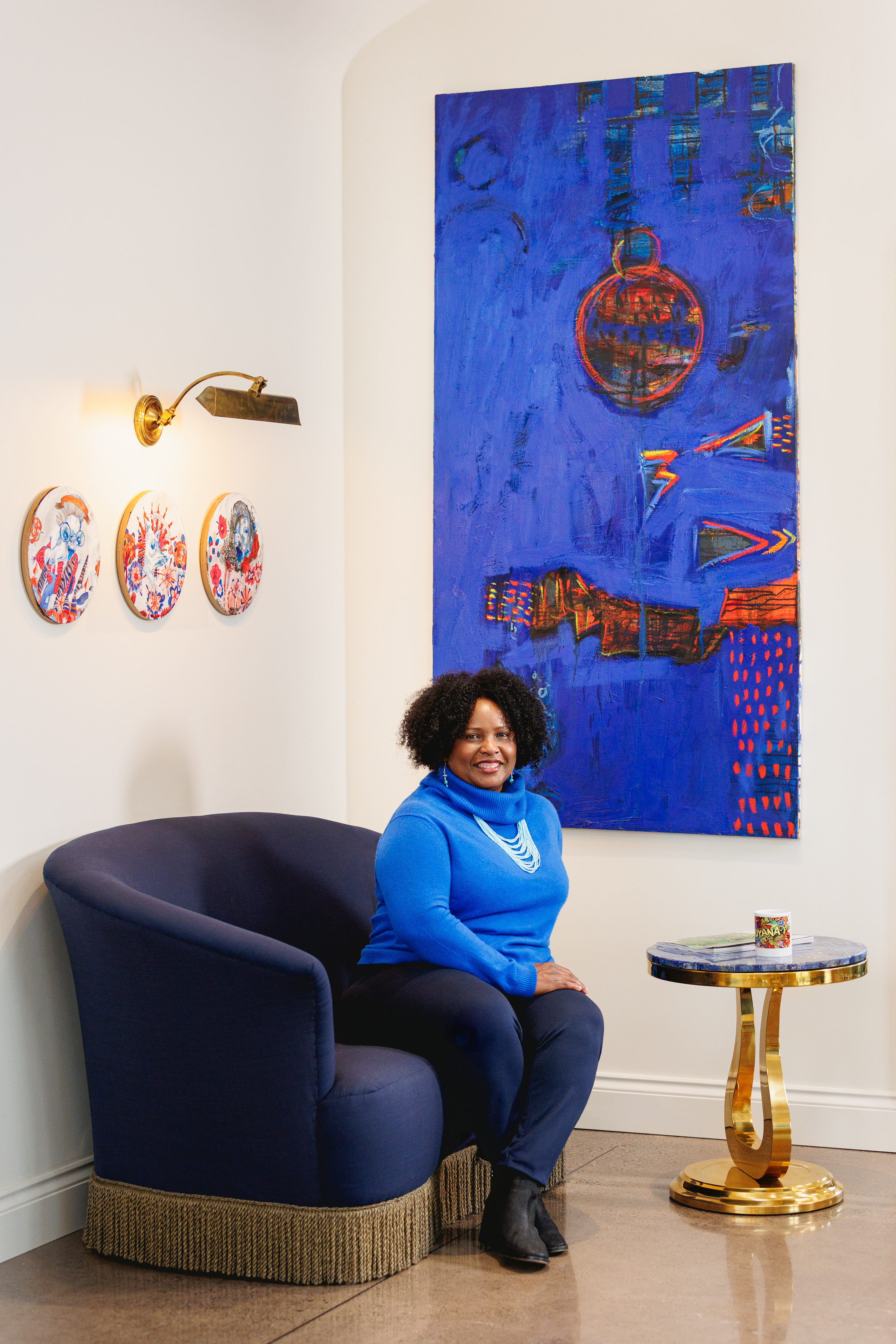 Mahalia Arjoon-Purchase, seated portrait with Guyanese art